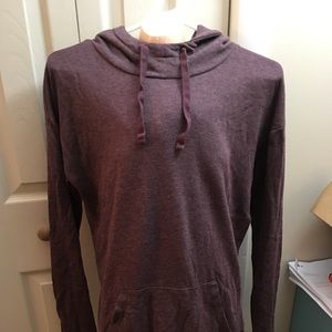 Tunic style sweater with a hoodie